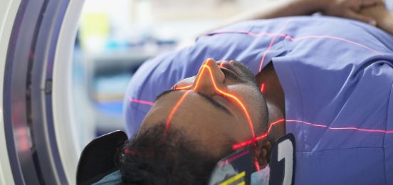 Mid adult male patient going through CAT scan